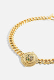 Close up of CAMILLA gold-plated Jaggi Necklace with signature lion-inspired pendant and bold statement chain.