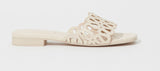 SIMKHAI Mccall laser cut cream leather flat slide sandal 
side view showing strap detail scalloped edge 
perforations and cream leather insole